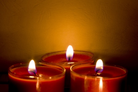 Red church candles burning  in subdued lightingの写真素材
