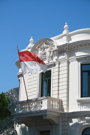 Coat of Arms and flag of Monaco on building, Monacoのeditorial素材