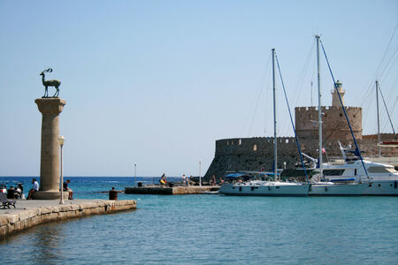 Entrance to Mandraki Port with St Nicholas Fort, Rhodes Town, Rhodes, Greeceのeditorial素材