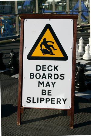 Warning sign of possible slippery boards on walkway of Southend Pier, Southend on Sea, Essex, Englandの写真素材
