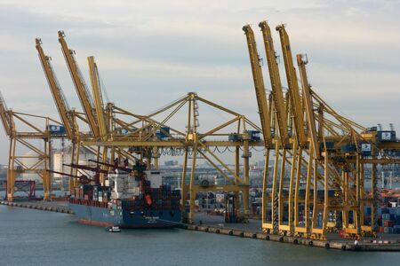 Container depot with ship unloading in port, Barcelona, Spainのeditorial素材