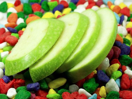sliced apple and funny colors stonesの写真素材
