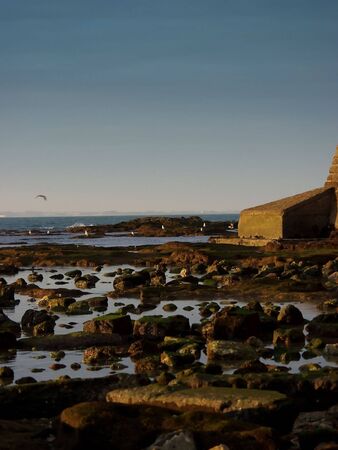 sunset over the rocks and seaの写真素材