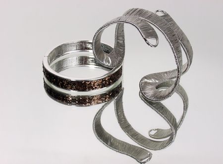 silver bracelets with pure reflection on background mirror
