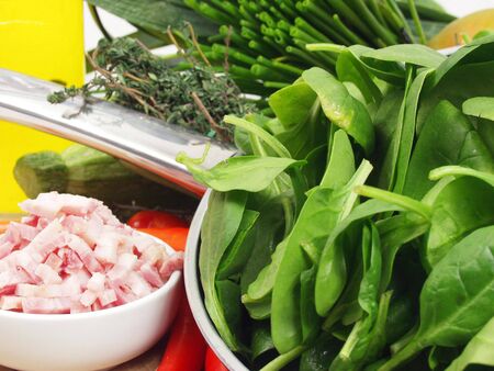 fresh green spinach with bacon and vegetables ready for cookの写真素材