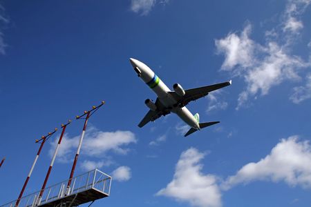Airliner on final approach with runway lights clearly visible. の写真素材