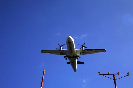 Airliner on final approach with runway lights clearly visible.