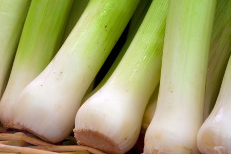 a row of leek in a basket on the fruitshop
