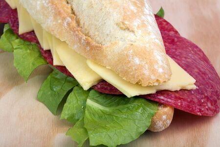 salami sandwich on wooden surface whit farmhousel breadの写真素材