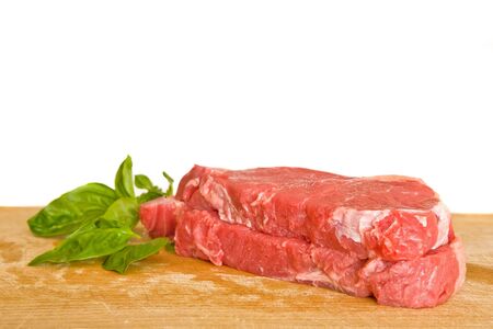 fresh and raw beef steak with green herbsの写真素材