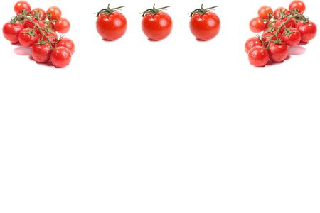 background of several cherry tomatoes on white cardの写真素材
