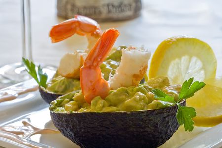 prawns and avocado salad served on white platterの写真素材