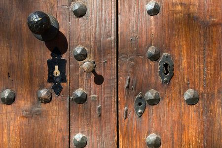 Old iron rust lock on brown wooden doorの写真素材