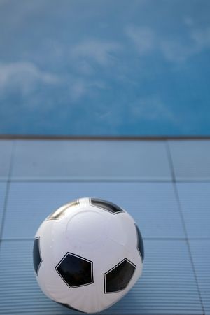 inflatable plastic ball floating on a calm swimming poolの写真素材