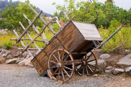 antique wood cart with big wheels on harvestの写真素材