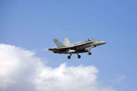 F-18 Hornet army airplane with gear extended for landing