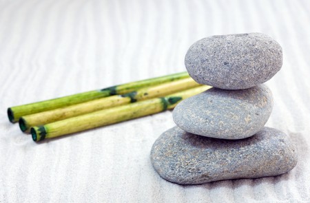 zen composition with stack of grey stone over sandの写真素材