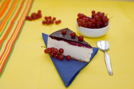 A delicious slice of cheesecake with fresh redcurrantの写真素材