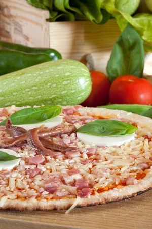 Delicious pizza with cheese and ham on decorated platterの写真素材