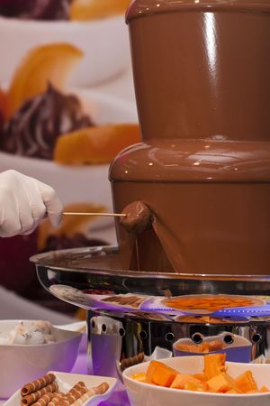 Fountain of milk chocolate for fruit dippingの写真素材
