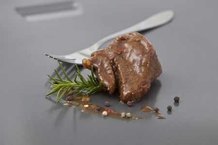 beef tenderloin with onion sauce on grey trayの写真素材