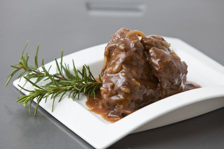 beef tenderloin with onion sauce on white trayの写真素材