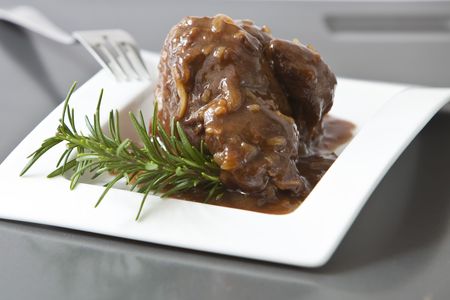 beef tenderloin with onion sauce on white trayの写真素材