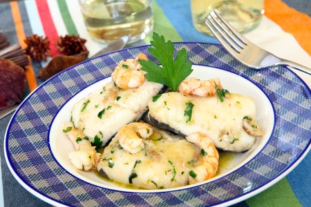 a fillet of hake with prawn on sauce