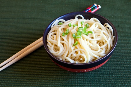 a bowl of chinese noodles with chopstickの写真素材