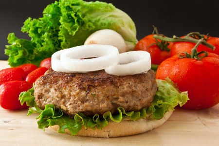 homemade burger with white onion and tomato