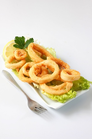 deep fried calamari with lettuce and lemonの写真素材