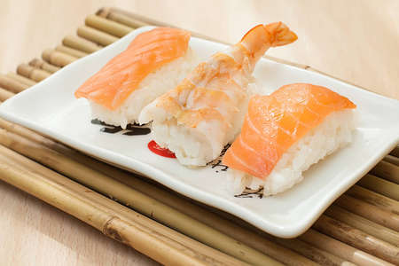 salmon and prawn nigiri sushi on white trayの写真素材