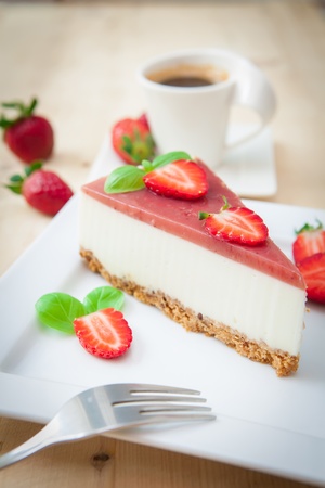 a piece of strawberry cheesecake on white trayの写真素材