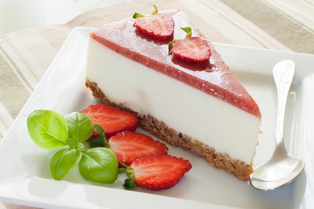 a piece of strawberry cheesecake with kiwi fruitの写真素材