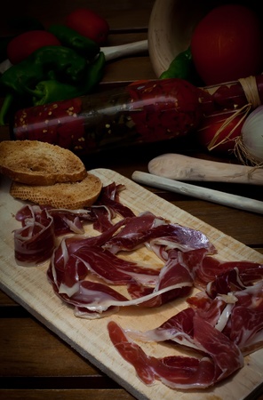 Spanish red ham table with grilled breadの写真素材