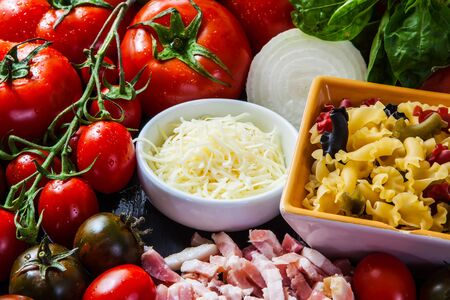 raw ingredients for italian pasta with vegetables and bacon
