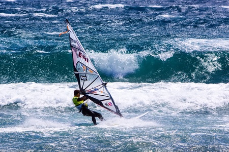 POZO IZQUIERDO, CANARY ISLANDS, GRAN CANARIA - JUL. 11: A professional windsurfer competes at the International PWA Competition on JUL. 09, 2011 in Pozo Izquierdo beach, Gran Canaria. This event is under PWA rules.のeditorial素材