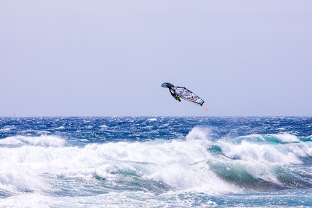 POZO IZQUIERDO, CANARY ISLANDS, GRAN CANARIA - JUL  11  A professional windsurfer competes at the International PWA Competition on JUL  09, 2011 in Pozo Izquierdo beach, Gran Canaria  This event is under PWA rules のeditorial素材