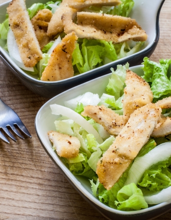 fresh caesar salad on bowl with parmesan cheeseの写真素材
