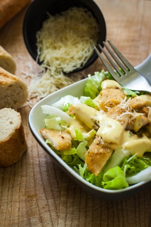 fresh caesar salad on bowl with parmesan cheeseの写真素材