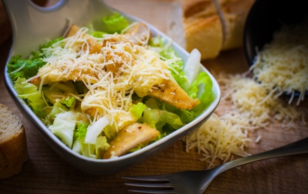 fresh caesar salad on bowl with parmesan cheeseの写真素材