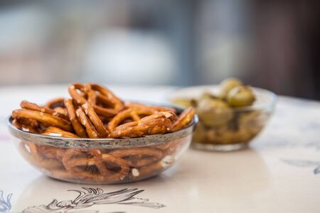 pretzel and olives on glass bowl in a barの写真素材