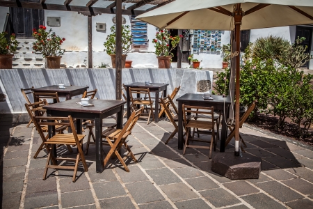 cafe outdoor terrace with umbrellas and chairの写真素材