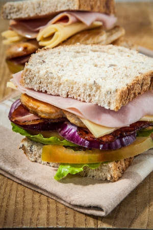 chicken breast sandwich with bacon ham and vegetablesの写真素材
