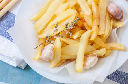 a bowl with french fries with garlic and oregano