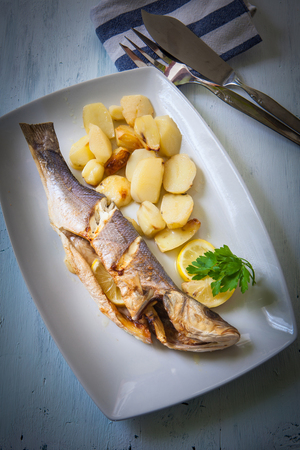 fresh seabass cooked with potatoes and lemonの写真素材