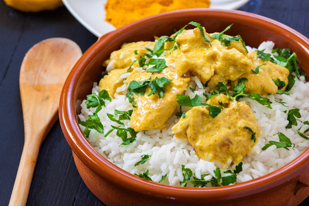 chicken curry with boiled rice and spicesの写真素材