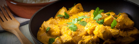 Butter chicken curry with basmati rice and cilantro.の写真素材