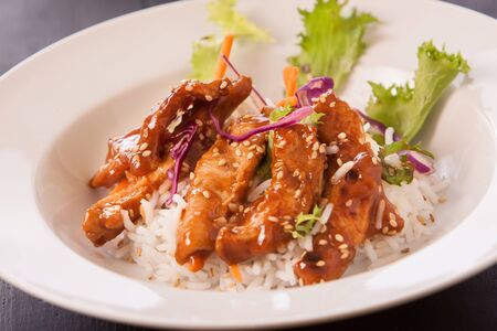 teriyaki chicken with salad and rice on trayの写真素材