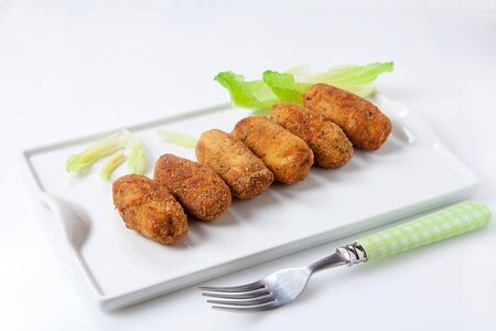 homemade chicken and vegetables croquettes on white tray
